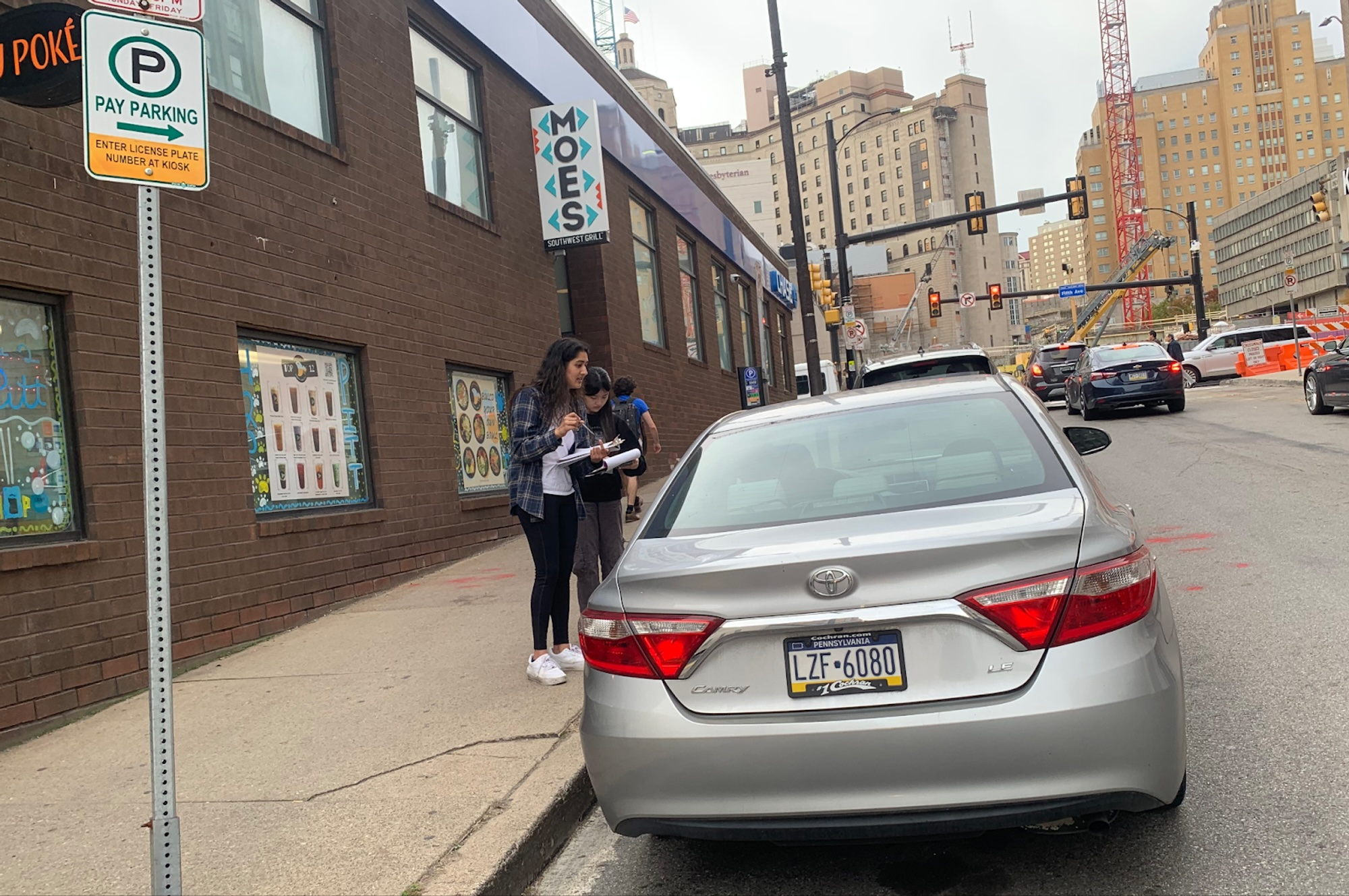 Researchers conducting on-site observation at a Pittsburgh loading zone